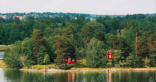 Preview: Panoramic View On Many Red Swedish Wooden Sauna Logs Cabins Houses On Island Coast In Summer Cloudy
