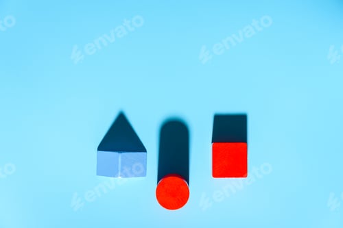 Preview: Three geometric figures of solid colors illuminated with hard light on simple blue background.