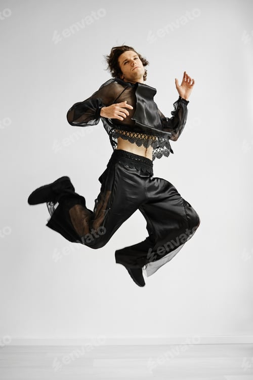Preview: Non binary man wearing lace outfit jumping