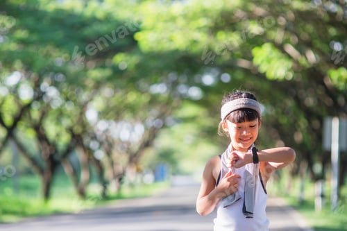 Preview: happy child girl running in the park in summer in nature. warm sunlight flare.