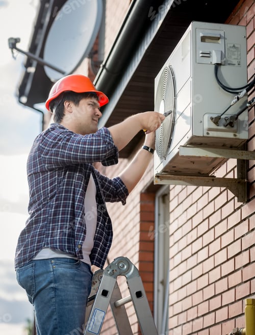 Preview: Male technician repairing outdoor air conditioning system