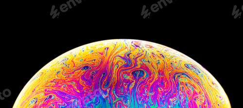 Preview: Rainbow soap bubble on a dark background. Close-up of colorful surface.