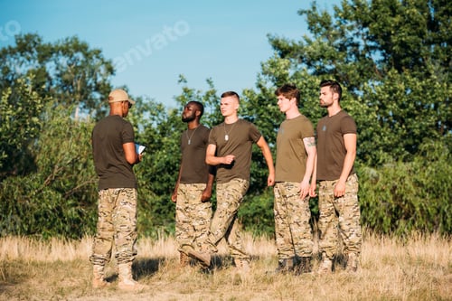Preview: african american tactical instructor with notepad and young multiethnic soldiers on range