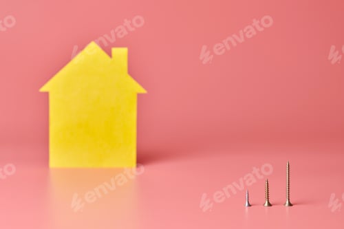 Preview: Home repair and redecorated concept. House renovation. Screws and yellow house shaped figure