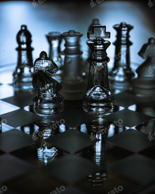 Preview: Selective focus shot of a glass chessboard in blue light - a concept of success