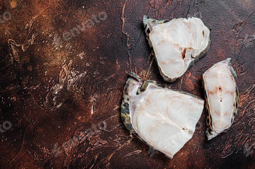 Preview: Raw atlantic wolffish fish Steak. Dark background. Top view. Copy space