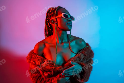 Preview: Attractive black ethnic woman with braids with red and blue led lights, trap dancer