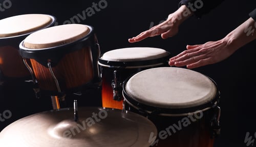 Preview: Drummer playing drums, different percussive musical instruments on a black background.