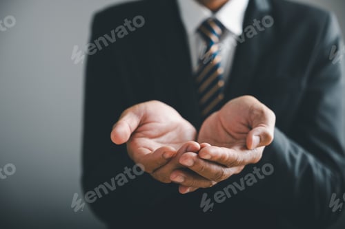 Preview: Close-up of businessman's open hands, ready to receive. He is wearing a suit with a striped tie.