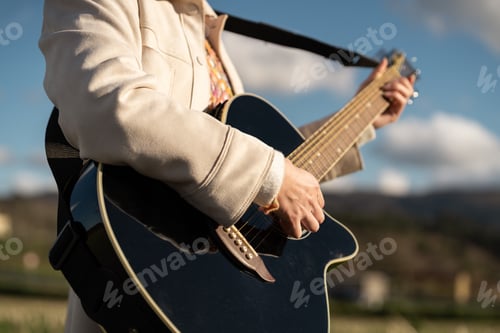 Preview: Adult Plays Acoustic Guitar Outdoors on Sunny Day