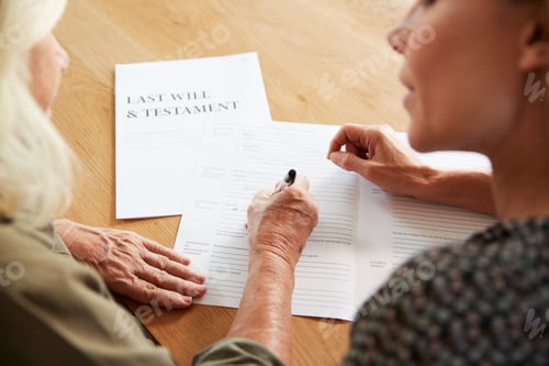 Preview: Female Friend Helping Senior Woman To Complete Last Will And Testament At Home
