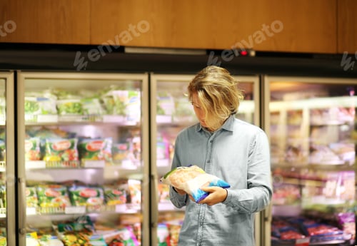 Preview: Man Choosing Frozen Food From A Supermarket Freezer