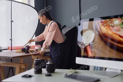 Preview: Black Woman Setting Up Equipment in Studio