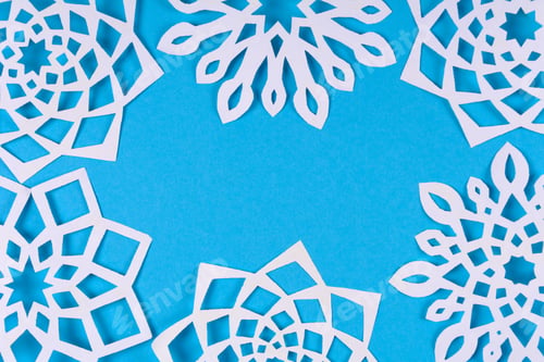 Preview: Paper snowflakes on blue background. Top view. Christmas decoration. Toned