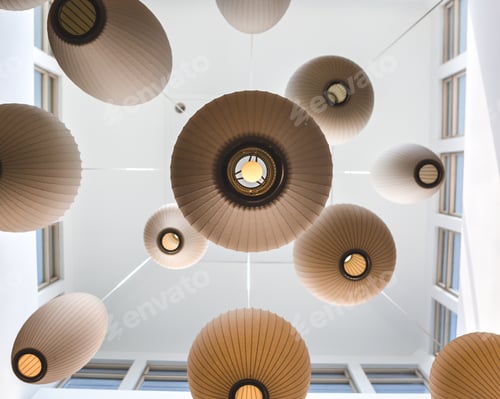 Preview: Underneath, looking up at a ceiling of circular lamps hanging