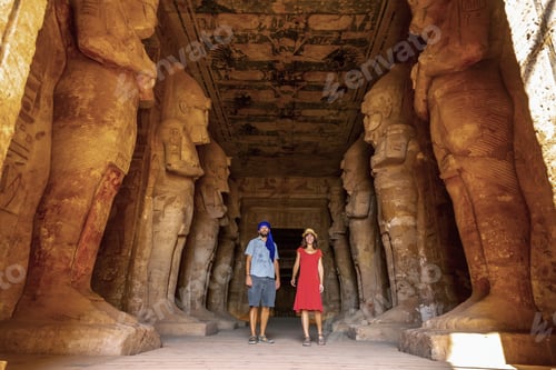 Preview: A tourist couple at the Abu Simbel Temple next to the sculptures, in southern Egypt