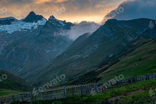 Preview: The Tour Du Mount Blanc in the Alps with green landscapes during the sunset