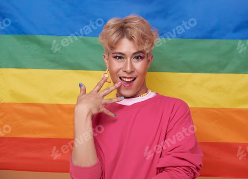 Preview: Youth asian transgender LGBT with Rainbow flag background.