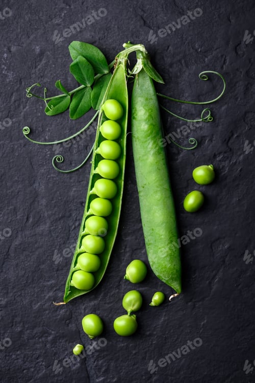 Preview: Green sugar snap peas with tendrils on black background