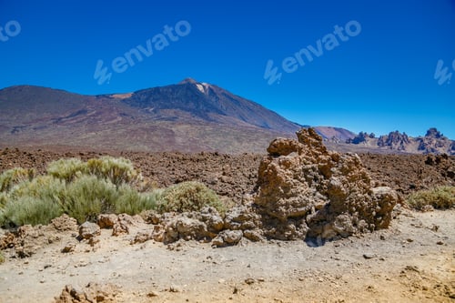 Preview: Mount Teide, a striking volcanic peak in Tenerife, stands majestically within a rugged landscape