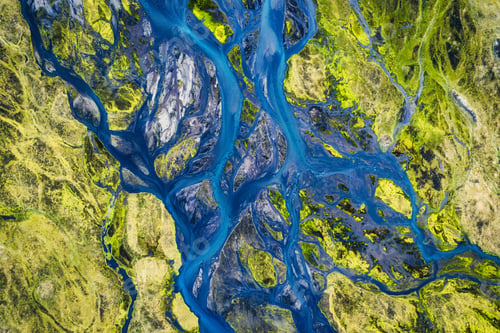 Preview: Blue glacier rivers pattern flowing through volcanic moss field in Icelandic highlands on summer