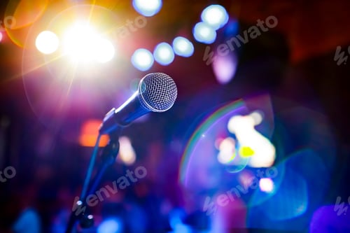 Preview: Microphone on stage against a background of auditorium.