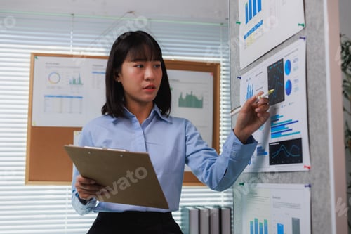 Preview: Businesswoman analyzing data on charts during presentation