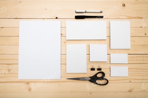 Preview: Stationery supplies arranged on a wooden table for creative projects and organization activities