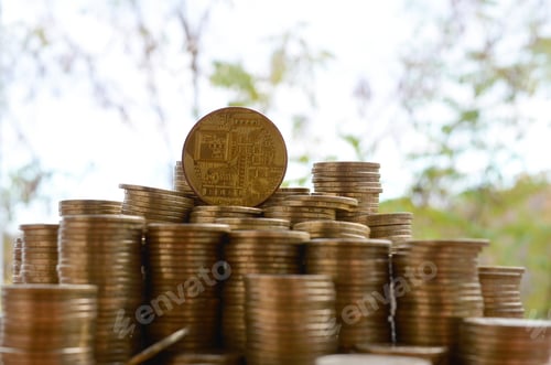 Preview: Big amount of bitcoin stacks on blurred green trees background close up