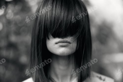 Preview: stylish woman with chic black haircut posing in elegant black and white portrait