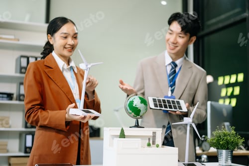Preview: Business people having consultation about wind energy at company office.