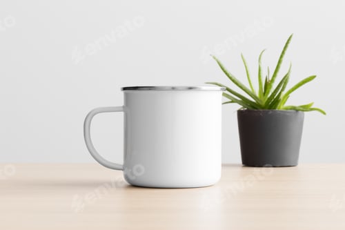 Preview: Enamel mug mockup with a aloe vera plant on the wooden table.