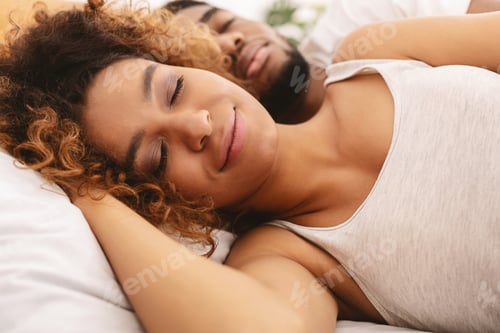 Preview: Loving couple sleeping in bed and hugging
