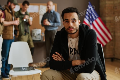 Preview: Young unhappy man with post traumatic syndrome looking at camera