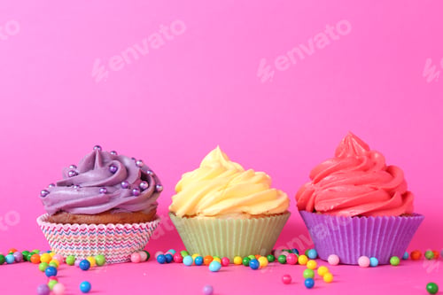 Preview: Delicious cupcakes with bright cream and sprinkles on pink background. Space for text
