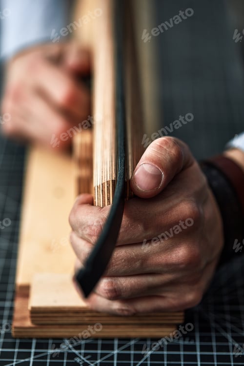 Preview: leather craftsmen working making measupenets in patterns at table in workshop studio