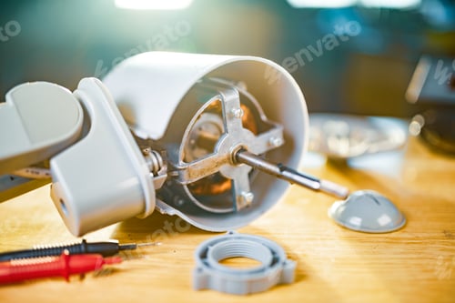 Preview: Close-up of iron motor from home cooling fan lies on a table