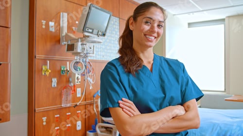 Preview: Portrait Of Female Doctor Or Nurse Wearing Scrubs At Work Standing Beside Hospital Equipment