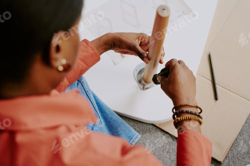 Preview: Black Woman Assembling Furniture at Home for Diy Lifestyle Concept
