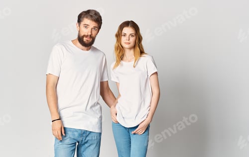 Preview: A man and a woman in jeans and a T-shirt are gesturing with their hands fun emotions Copy Space