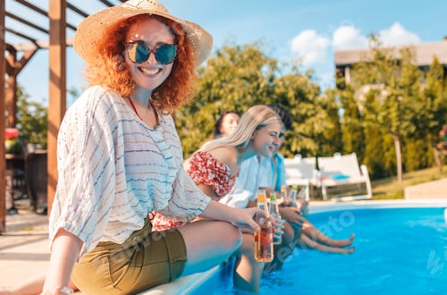 Preview: Group of friends having fun at summer vacation enjoying at poolside party.