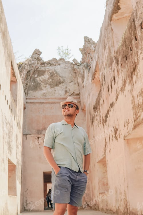 Preview: Joyful Asian man standing inside of Tamansari ruin building, Yogyakarta.