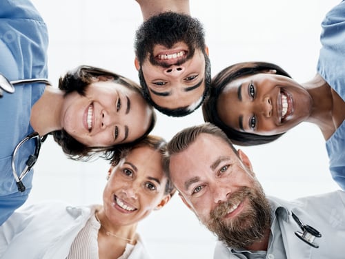 Preview: Portrait of a group of medical practitioners joining their heads together in a huddle