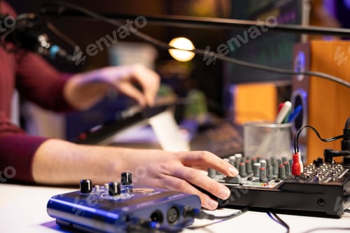 Preview: Sound engineer twisting pre amp knobs to mix and master songs