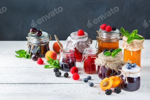 Preview: Assortment of seasonal berries and fruits jams in jars
