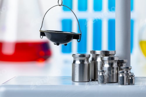Preview: Laboratory scales with weights against test tubes