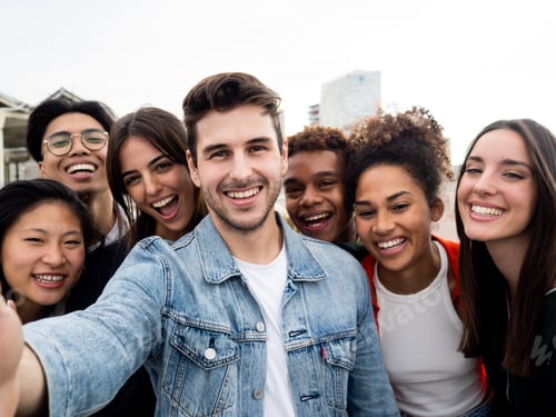 Preview: Group of smiling diverse young friends enjoying taking a selfie. Selfie perspective