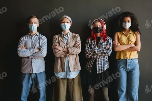 Preview: Multiracial man and women in face mask looking at camera