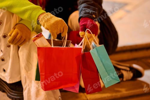 Preview: People holding colorful shopping bags after shopping spree
