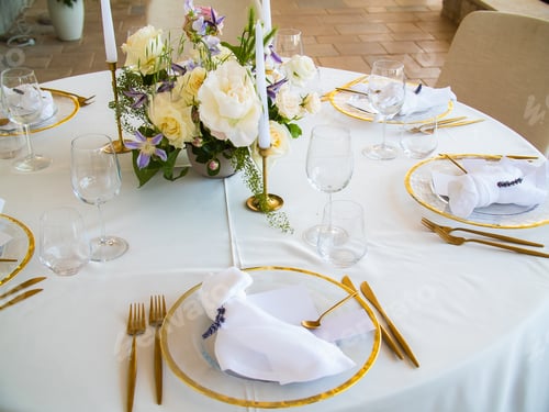 Preview: Wedding banquet concept. Chairs and round table for guests, served with cutler and, flowers and